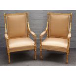 A pair of Louis XVI style gilt framed square back open armchairs, on fluted supports,