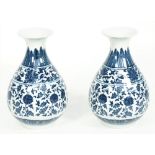 A pair of modern Chinese style porcelain vases, each foliate decorated against a waisted ground,