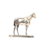 A silver plated model of a standing horse, on a rectangular rustic base, length of base 20cm.