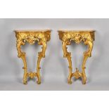 A pair of late 18th century French consoles, each with serpentine marble top,