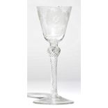 A Jacobite type wine glass, the rounded funnel bowl engraved with a rose, two buds and a star,