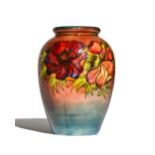 A Moorcroft pottery vase decorated in the 'Anemone' pattern, circa 1930, mottled blue/red ground,