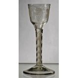 An opaque twist wine glass, circa 1765, the ogee bowl engraved with fruiting vine and a bird,