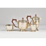 Silver tea wares, comprising; a teapot with brown composition fittings, Birmingham 1930,