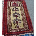 A Beluchistan prayer rug, the pale camel mehrab rising to a mosque, 147cm x 97cm.
