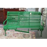 A 19th century green painted cast-iron garden bench with wooden slatted seat,