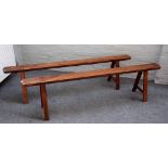 A pair of 19th century French fruitwood benches on splayed staked square supports,