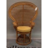 An early 20th century wicker peacock armchair, 73cm high x 144cm high.