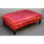 A large 20th century red leather upholstered rectangular footstool, on tapering square supports,