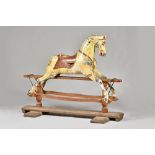 A large wooden rocking horse, early 20th century, probably by Ayres, dapple grey,