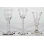 An airtwist wine glass, mid 18th century, the rounded funnel bowl engraved with an `oxo' border,