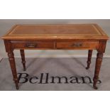 A Victorian mahogany two drawer writing table on ring turned supports, 114cm wide x 76cm high.