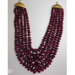 A five row necklace of graduated red stained hardstone beads, on a hook formed clasp,