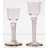 Two opaque twist wine glasses, circa 1765, each with ogee bowl,