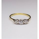 A gold and diamond set three stone ring,