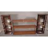 A pair of faux rosewood mirror back hanging four tier shelves, 32cm wide x 75cm high,