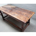 A 17th century oak refectory table, the cleated twin plank top on turned supports,