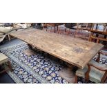 A large hardwood kitchen table, the cleated plank top graffiti decorated with oak tree,