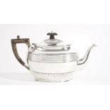 A late Victorian silver teapot, of oval form, with fluted and banded decoration,