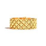 An 18ct gold wide bracelet, designed as a series of lozenge shaped floral links, on a snap clasp,