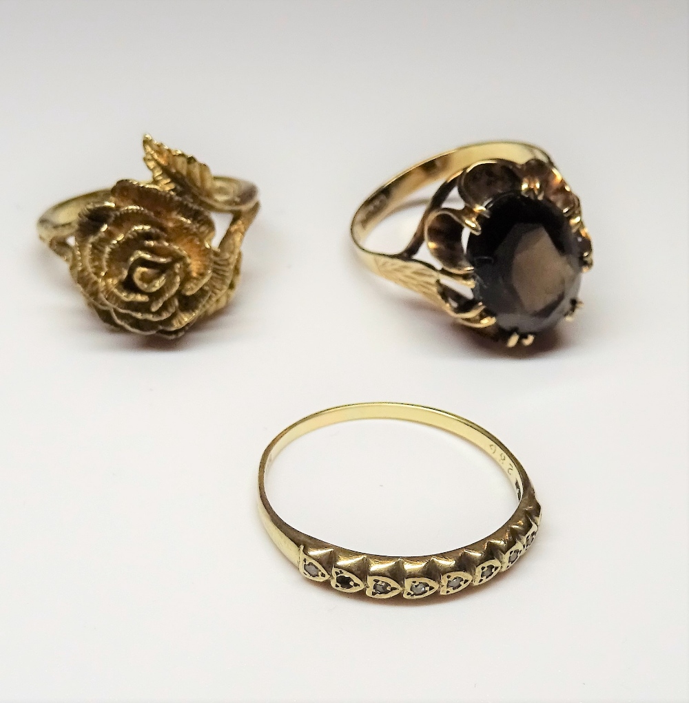 A 9ct gold ring, claw set with an oval cut smoky quartz, ring size S, a 9ct gold ring,
