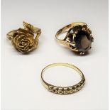 A 9ct gold ring, claw set with an oval cut smoky quartz, ring size S, a 9ct gold ring,