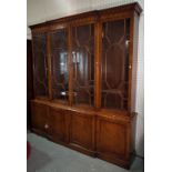 A George III style yew wood breakfront bookcase cabinet with astragal glazed doors on plinth base,