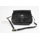 A Gucci style black leather lady's handbag with gilt metal hardware and adjustable shoulder strap,