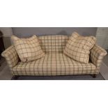 A modern green chequered upholstered sofa with roll over arms on tapering fluted supports,