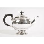 A silver teapot, of shaped circular form, having a decorated rim,