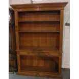 A 20th century stained beech open bookcase with two short central drawers on plinth base,