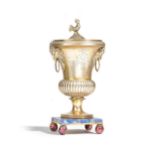A French Empire silver gilt urn and cover, the body of bulbous form, with fluted decoration,