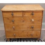 An early 20th century pine chest of two short and three long graduated drawers on turned supports,