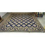 A Kashan carpet, Persian, the indigo field with diamond shaped floral leaf motifs,