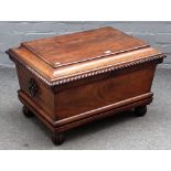 An early 19th century mahogany sarcophagus shaped cellarette, with gadrooned moulding,