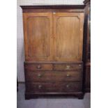 A George III mahogany linen press with moulded panelled doors over two short and two long graduated