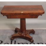 A Victorian walnut foldover tea table on octagonal turned column quaterfoil base,