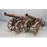 A pair of reproduction cast iron cannons, late 20th century, with circular tapering barrels,