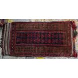 A Beluchistan bag, the indigo field with two columns of madder flowerheads, a brown flower border,