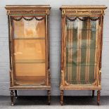 A pair of French Louis XVI style gilt framed vitrines, each with floral swag mounted glazed door,
