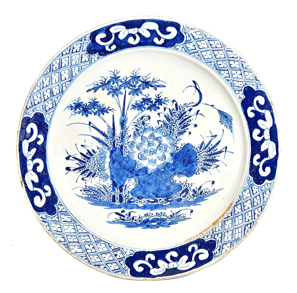 A large Bow blue and white plate, circa 1760-65, painted in the centre with a lotus flower, - Image 2 of 2