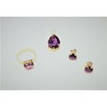 A gold ring, claw set with a curved triangular amethyst, detailed 750, ring size K,