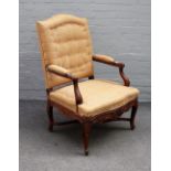 A 19th century walnut framed open armchair, with wing back and serpentine seat, on scroll supports,