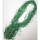 Twenty-one rows of rough emerald beads, (21).