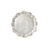 A George II silver salver, of shaped circular form, having a shell and pie-crust rim,