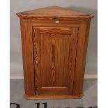 A late Edwardian pitch pine hanging corner cupboard, 76cm wide x 100cm high.