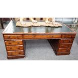 A 19th century mahogany partners desk with nine drawers about the knee and opposing cupboards,