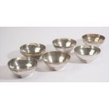 A set of six bowls, each of circular form, having a beaten finish, apparently unmarked,