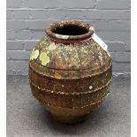 A terracotta oil jar of globular form with wrigglework bands, 45cm diameter x 55cm high.