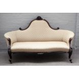 A Victorian tub back sofa, with carved mahogany show frame and serpentine seat, on scroll supports,